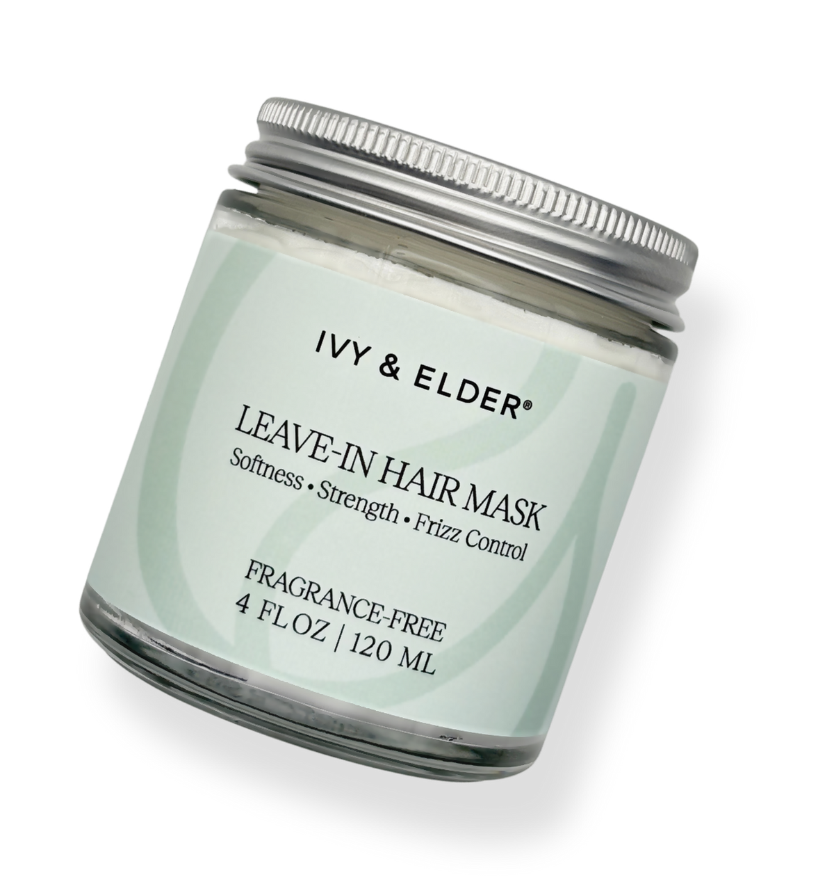 A glass jar of Ivy & Elder Leave-In Hair Mask with a silver metal lid and a pale mint green label, shown on a clean white background.