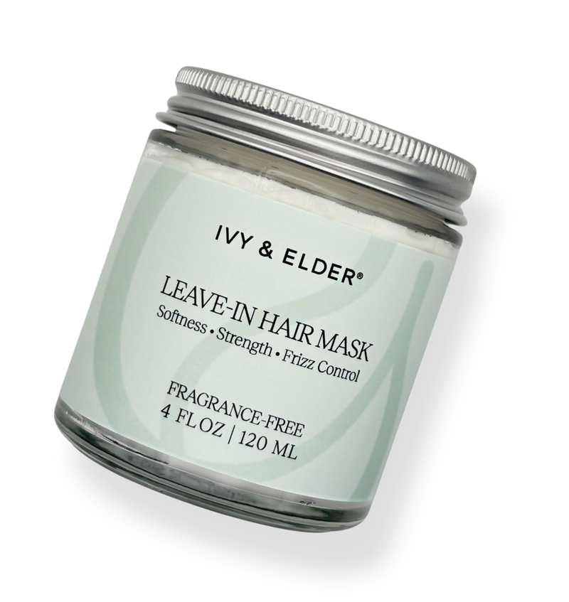 A glass jar of Ivy & Elder Leave-In Hair Mask with a silver metal lid and a pale mint green label, shown on a clean white background.